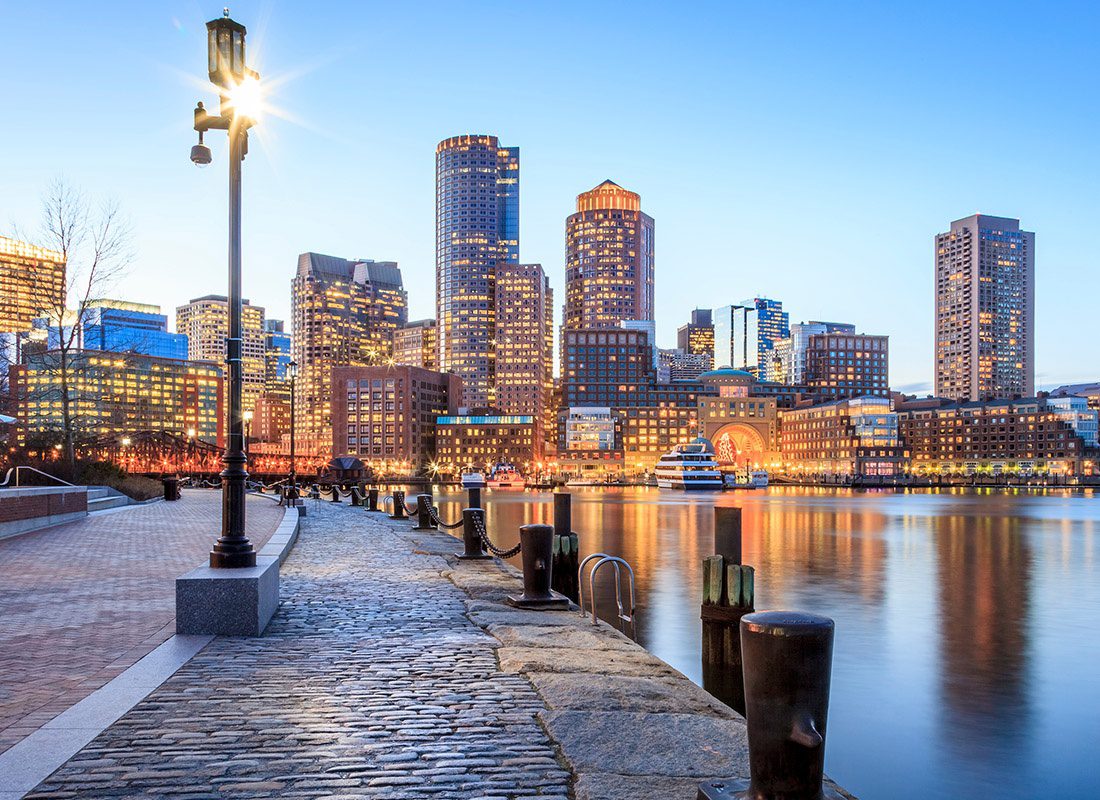 About Our Agency - Aerial View of the Boston Harbor and Financial District During the Evening